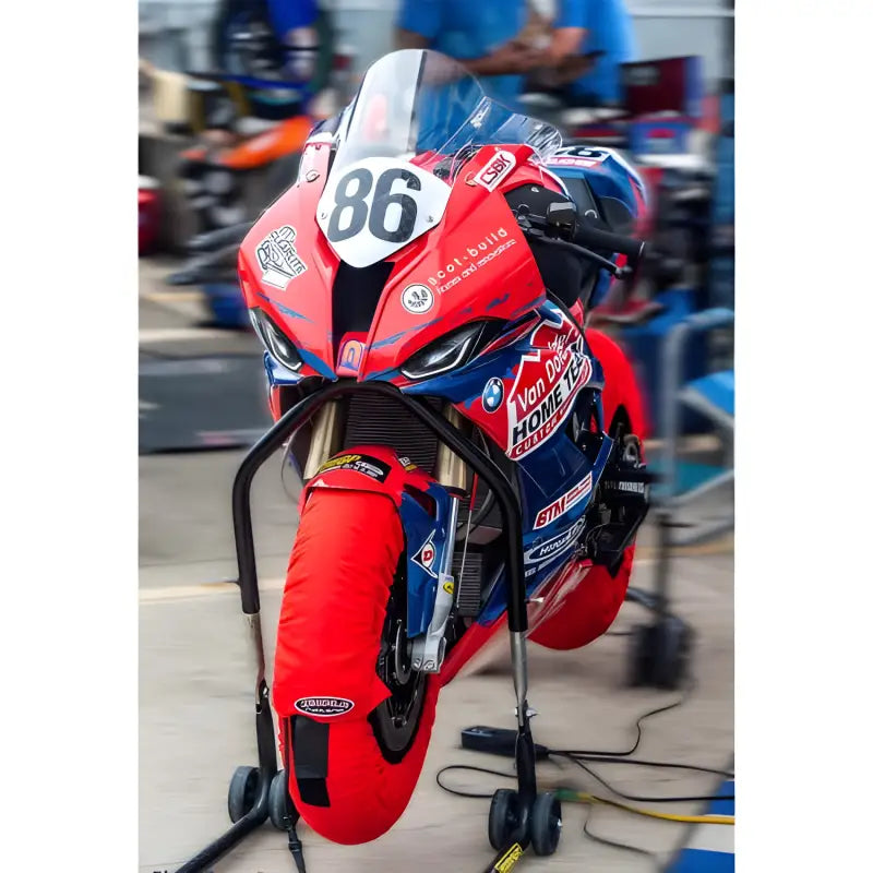 Motocyclette de course rouge et bleue avec couvertures chauffe-jantes programmable Bickle